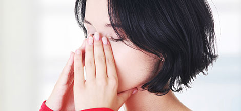 Lady holding nasal passage